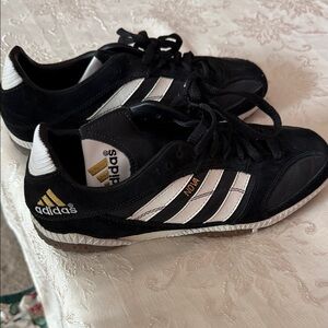 adidas Black Sneakers with White Stripes and Gold Accents
